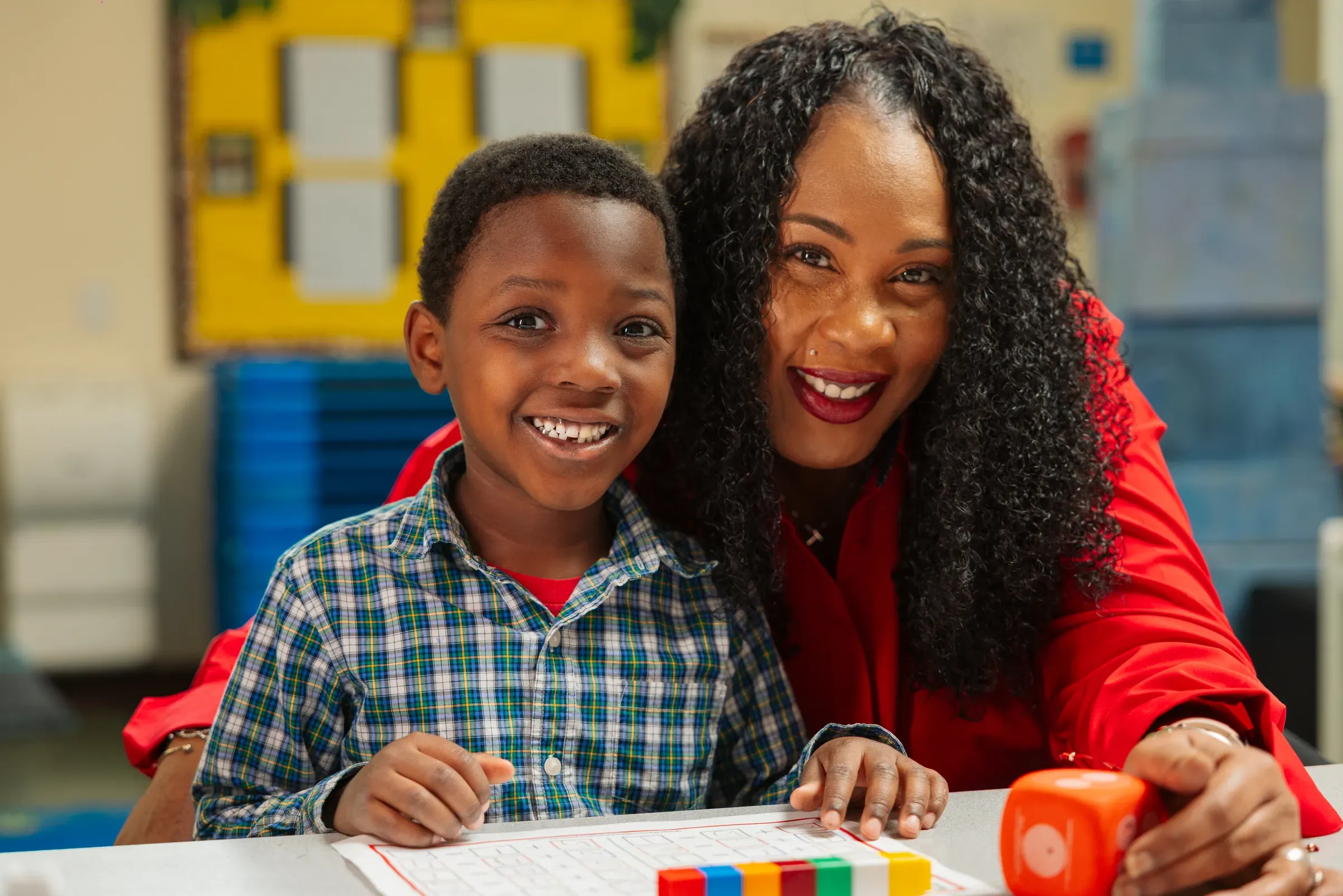A teacher working alongside a student during a photo session