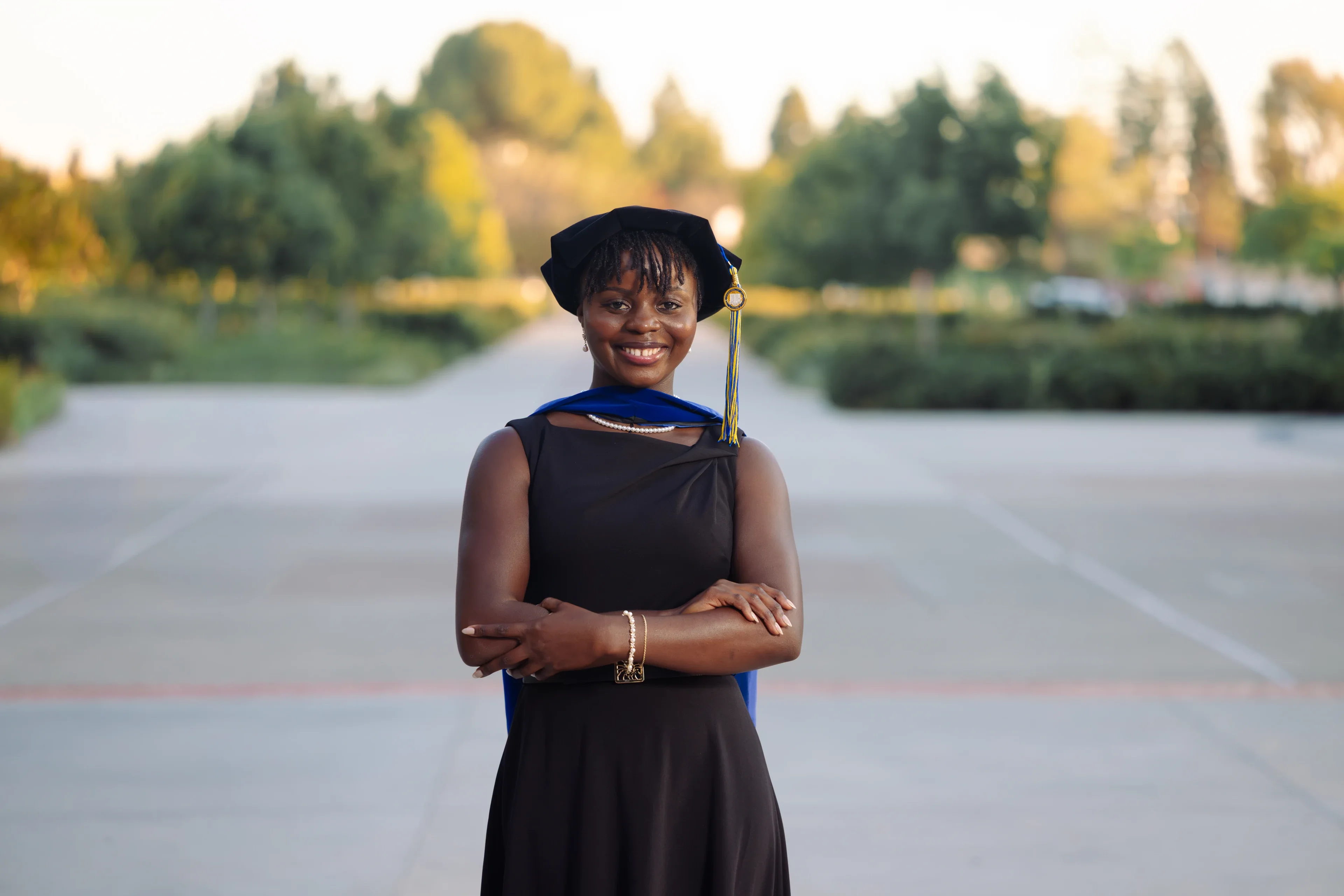 UC Irvine graduate holding her diploma in cap and gown