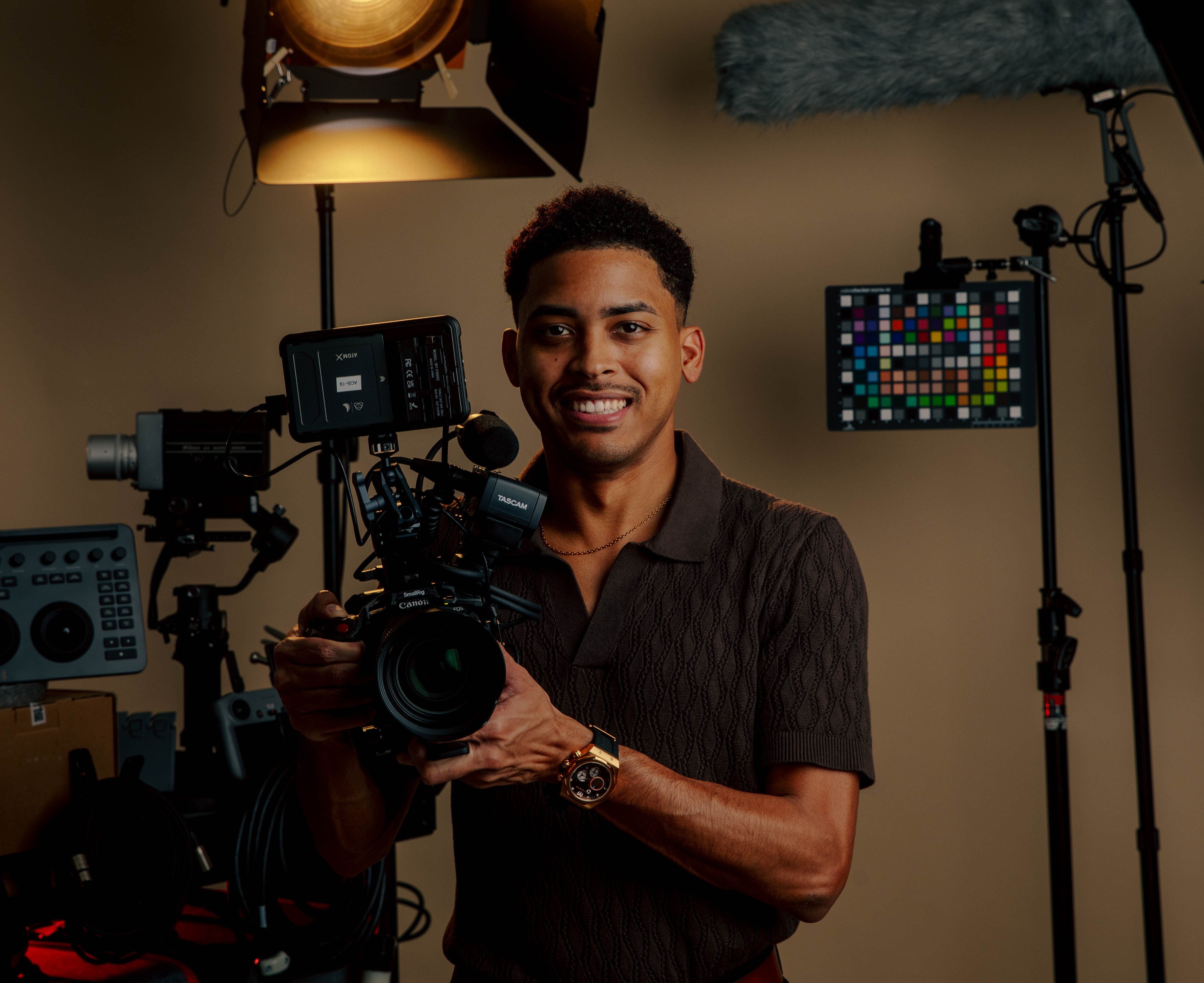 Michael Merchan holding a cinema camera in his studio