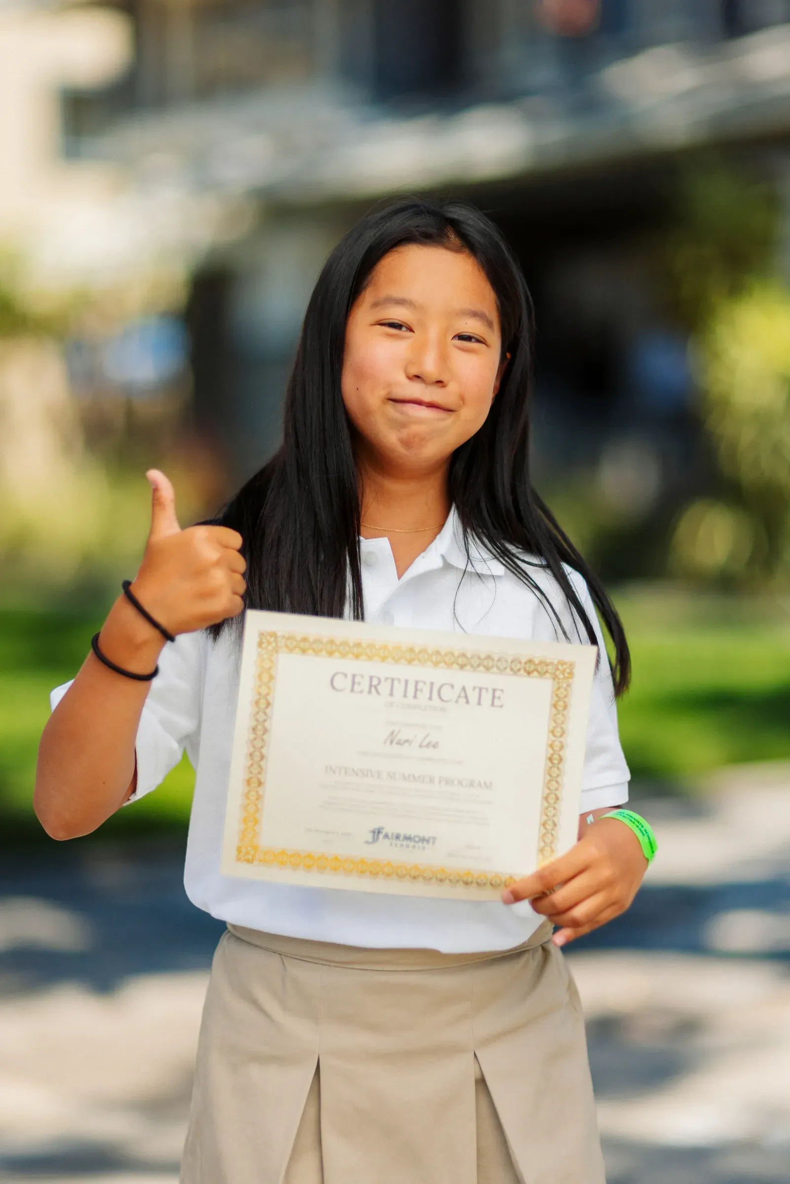 Student proudly holding a certificate