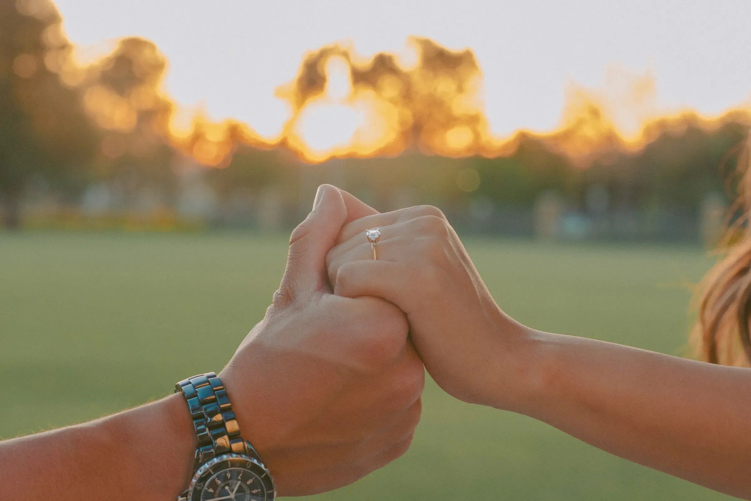 Close-up of hands intertwined after the proposal