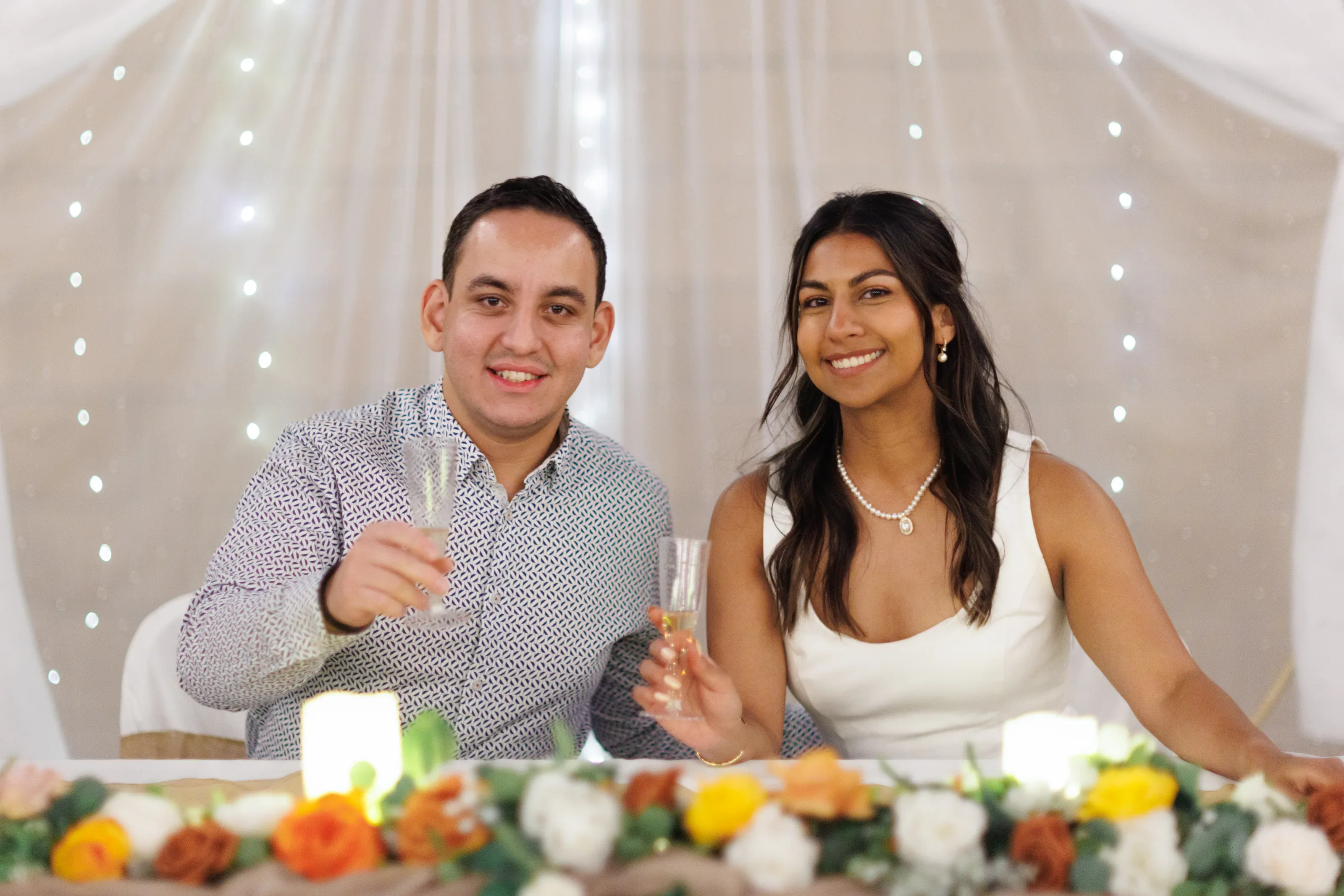 Laura and Daneil seated together at their evening reception